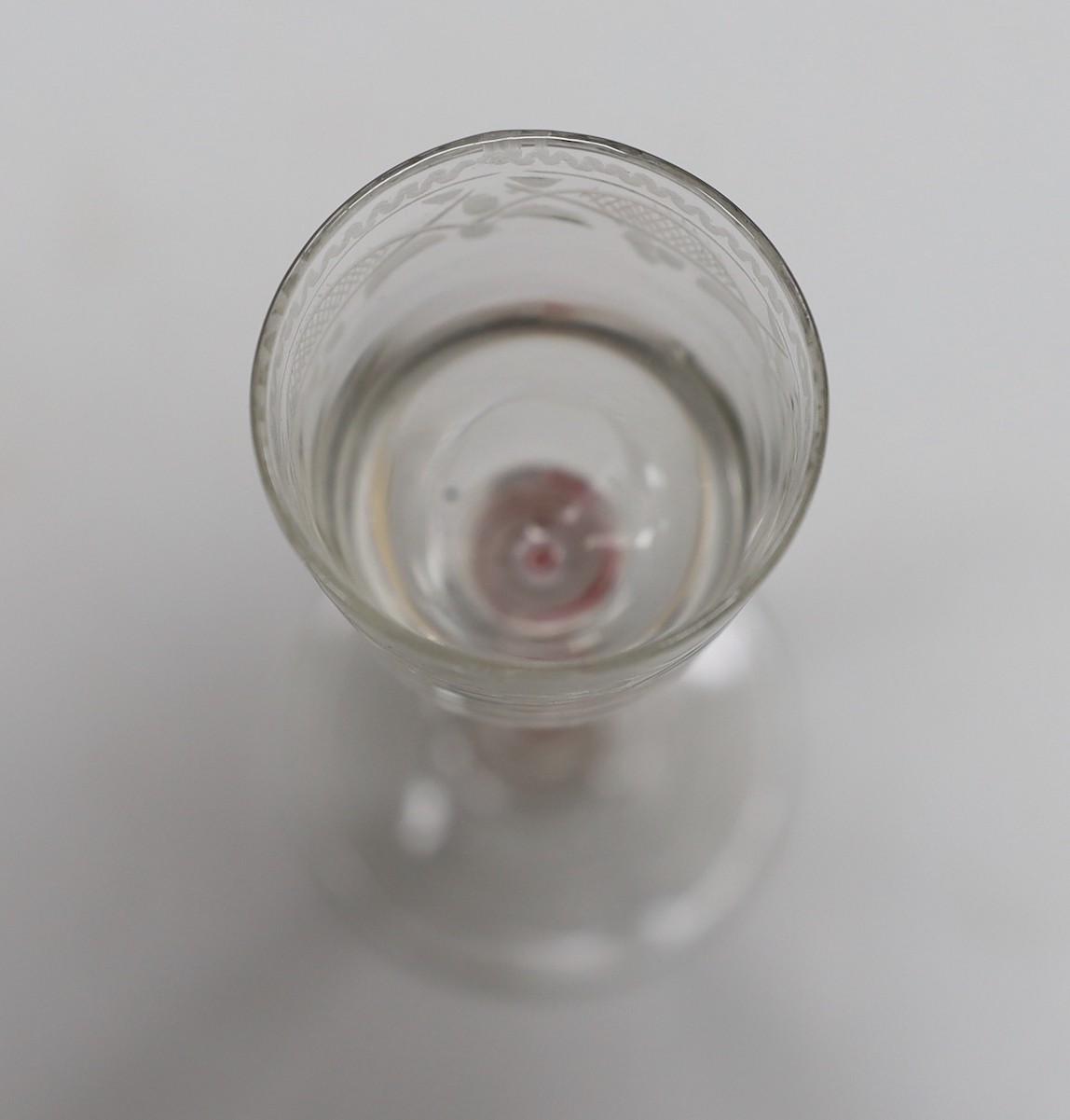A Dutch red and white colour twist stem cordial glass, 13cms high